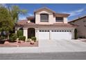 Charming two-story home with a spacious three-car garage and manicured landscaping at 1700 Double Arrow Pl, Las Vegas, NV 89128