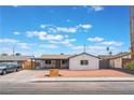Charming single-story home with xeriscaped front yard and modern wooden address block on a sunny day at 1808 E Saint Louis Ave, Las Vegas, NV 89104