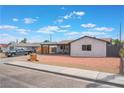 Street view of a single story house featuring a xeriscaped front yard and modern wooden address block at 1808 E Saint Louis Ave, Las Vegas, NV 89104
