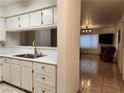 Bright kitchen with white cabinets flows into living room with fireplace at 2016 Mesquite Ln # 104, Laughlin, NV 89029