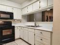 Clean kitchen features white cabinets and black appliances for contrast at 2016 Mesquite Ln # 104, Laughlin, NV 89029