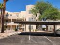 Condo building exterior showcasing covered parking with clearly marked spaces at 2016 Mesquite Ln # 104, Laughlin, NV 89029