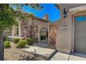 Charming home featuring a stone accented entry way with wrought iron gate and desert landscaping at 2172 De Rouge Ave, Henderson, NV 89044