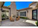Inviting outdoor patio with a fireplace, sliding glass doors, and comfortable seating area at 2172 De Rouge Ave, Henderson, NV 89044