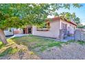 Quaint single-story home featuring a covered patio, fresh lawn, and a secure gated entrance at 304 Perkins Cir, Las Vegas, NV 89106