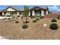 Well-maintained front yard featuring desert landscaping with drought-tolerant plants and rock features at 31 White Burch Ln, Pahrump, NV 89048