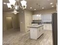 Stylish open-concept kitchen with an island, stainless steel appliances, and ample cabinet space at 31 White Burch Ln, Pahrump, NV 89048