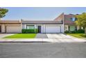 Charming home features a two-car garage, manicured lawn, and lovely front entrance at 3380 Kensbrook St, Las Vegas, NV 89121