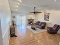 Cozy living room features a brick fireplace, hardwood floors, and sliding doors to the backyard at 3585 Winner Dr, Las Vegas, NV 89120