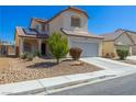 Attractive home featuring well-kept landscaping and a two-car garage at 3828 Prairie Orchid Ave, North Las Vegas, NV 89081