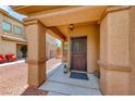 Charming front porch with decorative wreath and lantern, creating a welcoming entrance at 4421 Galapagos Ave, North Las Vegas, NV 89084