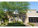 Home featuring stone and stucco design, mature trees, and professional landscaping at 50 Grey Feather Dr, Las Vegas, NV 89135