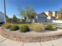 Charming single-story home featuring a two-car garage, a well manicured lawn and decorative brickwork at 6292 Yucca Valley Ct, Las Vegas, NV 89142