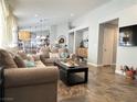 Bright living room with tile flooring, comfortable seating, and neutral color scheme at 6292 Yucca Valley Ct, Las Vegas, NV 89142