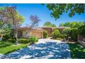 Charming single story home featuring an attached garage and meticulously maintained landscaping at 63 Feather Sound Dr, Henderson, NV 89052