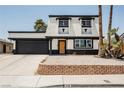 Charming two-story home with a modern black-and-white exterior, complemented by a well-maintained front yard at 716 Vincent Way, Las Vegas, NV 89145