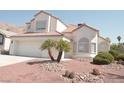 Charming two-story home featuring tile roof and two-car garage with desert landscaping at 7253 Alsop Ct, Las Vegas, NV 89156