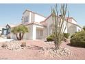 Desert landscaping complements this light-colored two story home with tile roofing at 7253 Alsop Ct, Las Vegas, NV 89156