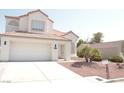 Charming two-story home with a tile roof, a two-car garage, and desert landscaping at 7253 Alsop Ct, Las Vegas, NV 89156