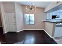 Open-concept dining room featuring hardwood floors, contemporary lighting, and access to the kitchen at 8455 W Sahara Ave # 213, Las Vegas, NV 89117