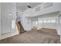 Bright living room with high ceilings, staircase, and an open floor plan into the dining area at 8529 Gold Flash Ave, Las Vegas, NV 89129
