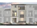 Modern townhome with multi-level balconies and stone accents on the exterior elevation at 8683 Luxuriant Ave # Lot 26, Las Vegas, NV 89148