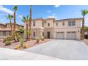 Front exterior view of a home showing desert landscaping with cactus and palm trees, and an attached two-car garage at 8824 Killians Greens Dr, Las Vegas, NV 89131