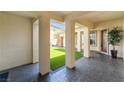 Covered patio space with a view of an artificial grass lawn at 8824 Killians Greens Dr, Las Vegas, NV 89131