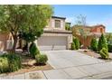 Inviting two-story house with a spacious driveway and well-manicured front yard at 9074 Iron Cactus Ave, Las Vegas, NV 89148
