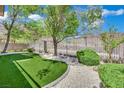View of backyard featuring artificial turf, desert landscaping and rock features at 96 Saint Johns Wood Ave, Henderson, NV 89002