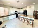 Bright kitchen featuring granite countertops, black appliances, and a spacious center island with bar seating at , Las Vegas, NV 89179