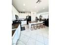Spacious kitchen with granite countertops, black appliances, an island with bar stools, and ample storage at , Las Vegas, NV 89179