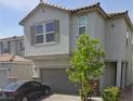 Charming two-story home with a two-car garage, stone accents, paved driveway and lush landscaping at 10163 Kings Amethyst St, Las Vegas, NV 89141