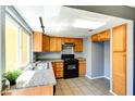 Charming kitchen boasts granite countertops, wood cabinets, black appliances, and tile flooring at 1480 Hialeah Dr # B, Las Vegas, NV 89119