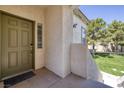 Inviting front door of the home, complemented by a well-manicured lawn and greenery at 1705 King James St # 203, Las Vegas, NV 89144