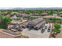 An aerial view revealing a workshop with ample parking space, and neighboring properties at 1919 Belcastro St, Las Vegas, NV 89117