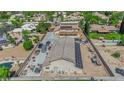 An aerial view of the home showing a large workshop with parking, solar panels and a pool at 1919 Belcastro St, Las Vegas, NV 89117