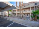 Condominium building with exterior walkways, mature palm trees, and desert landscaping at 2068 Mesquite Ln # 203, Laughlin, NV 89029
