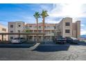 Condominium building with covered parking featuring desert landscaping on a sunny day at 2068 Mesquite Ln # 203, Laughlin, NV 89029