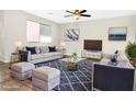 Bright living room with stylish sofas, a modern rug, and ample natural light at 2175 Limestone Cove Ct, Laughlin, NV 89029