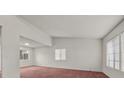 Bright living room with multiple windows and red carpet at 2344 Valleywood St, Henderson, NV 89014