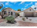 Charming single-story home with desert landscaping, tile roof, and a two-car garage at 2860 Misty Ct, Henderson, NV 89074