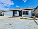 Charming white stucco home with black trim and concrete driveway at 3215 Dillon Ave, North Las Vegas, NV 89030