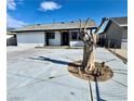 Exterior of a home featuring white stucco, black trim, and a concrete driveway at 3215 Dillon Ave, North Las Vegas, NV 89030