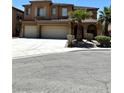 Two-story home with large three car garage, desert landscaping, and beautiful architecture at 3221 Villa Pisani Ct, North Las Vegas, NV 89031