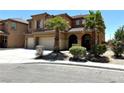 Two-story home with large three car garage, desert landscaping, and beautiful architecture at 3221 Villa Pisani Ct, North Las Vegas, NV 89031