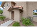 Charming front entrance with a covered porch, tiled roof, and desert landscaping at 3363 Pavlo St, Las Vegas, NV 89121