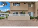 Private patio area with a low white fence, mature plants, and a glimpse of the building's exterior at 3363 Pavlo St, Las Vegas, NV 89121