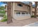 Private patio area with a low white fence, mature plants, and a glimpse of the building's exterior at 3363 Pavlo St, Las Vegas, NV 89121