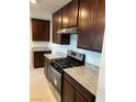 Well-lit kitchen with stainless steel appliances and granite countertops offers a modern cooking space at 4056 Campeche Ave, Las Vegas, NV 89121